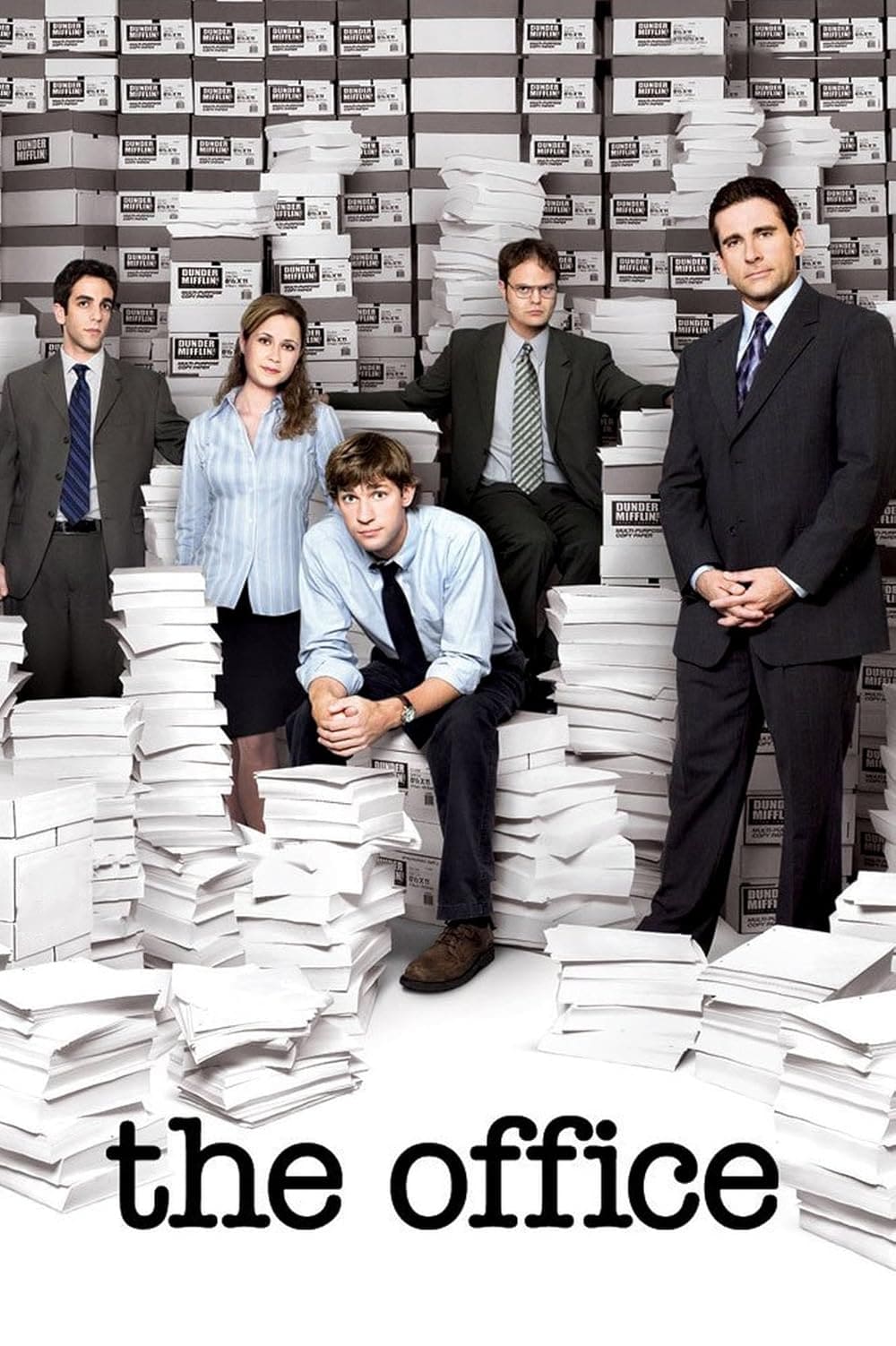 Five office workers pose amid large stacks of paper and boxes, giving a glimpse into their busy workplace. The words “the office” appear at the bottom, subtly nodding to everyday moments captured on screen—perfect for fans of IPTV BrasiL or anyone catching up on their favorite Brasil IPTV series.